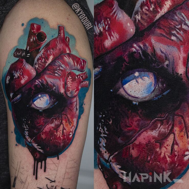 Tattoo Serce in colorful motif and realistic style on the upper arm
