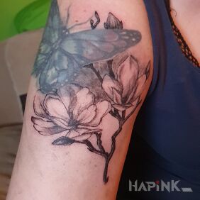 Tattoo Magnolia on the upper arm motif: flowers style: graphic / illustrative