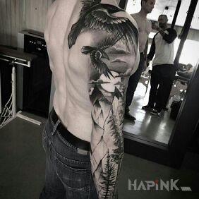 Tattoo Two birds in the sky on the upper arm motif: black and gray style: graphic / illustrative