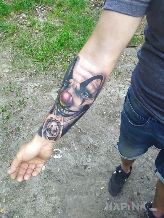 Tattoo Megastyczny in faces motif and realistic style on the forearm