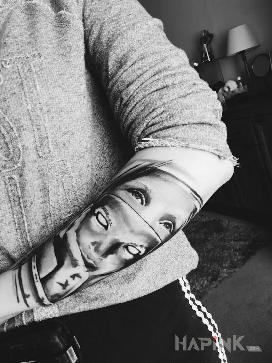 Tattoo Mask in faces motif on the forearm