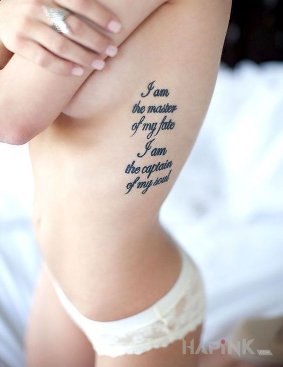 Tattoo Mistrz przeznaczenia in lettering motif and calligraphy style on the ribs