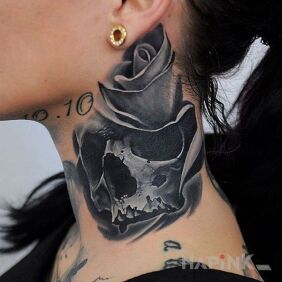 Tattoo Chest and flower on the neck motif: skulls