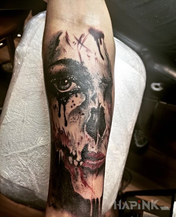 Tattoo Horror tattoo in faces motif and realistic style on the forearm