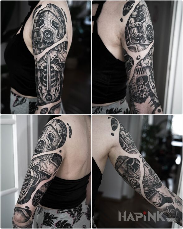 Tattoo Steampunk in ripped skin motif and biomechanics style on the upper arm
