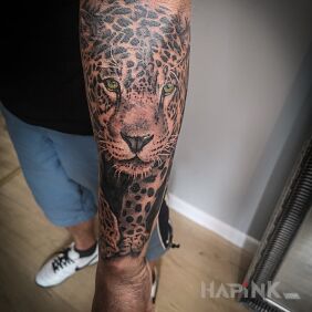 Tattoo Sneaking leopard on the forearm motif: animals style: realistic