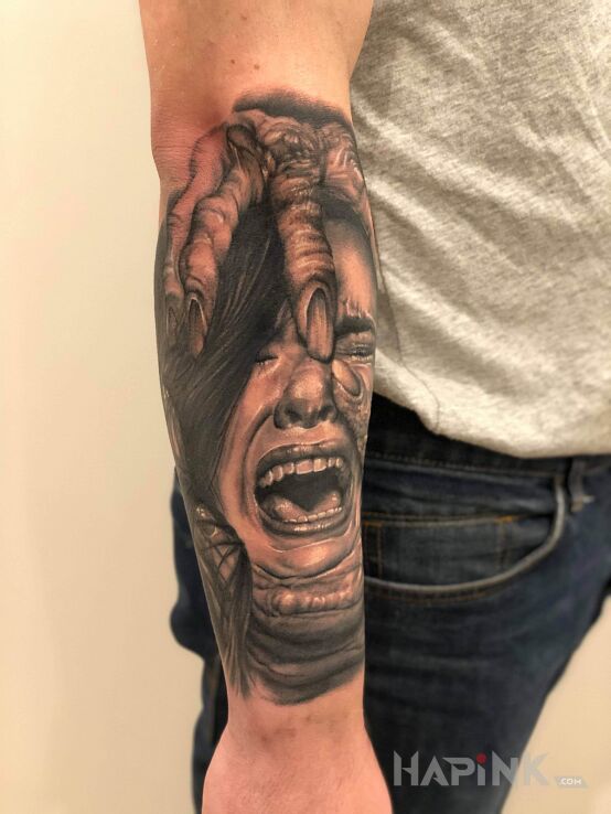 Tattoo Mega in black and gray motif and realistic style on the forearm