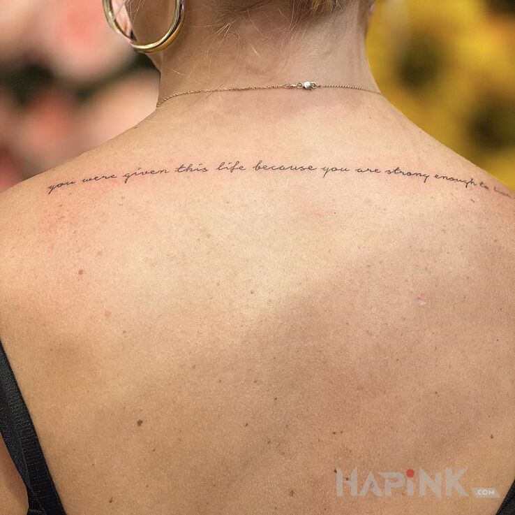 Tattoo Życie in lettering motif and calligraphy style on the back