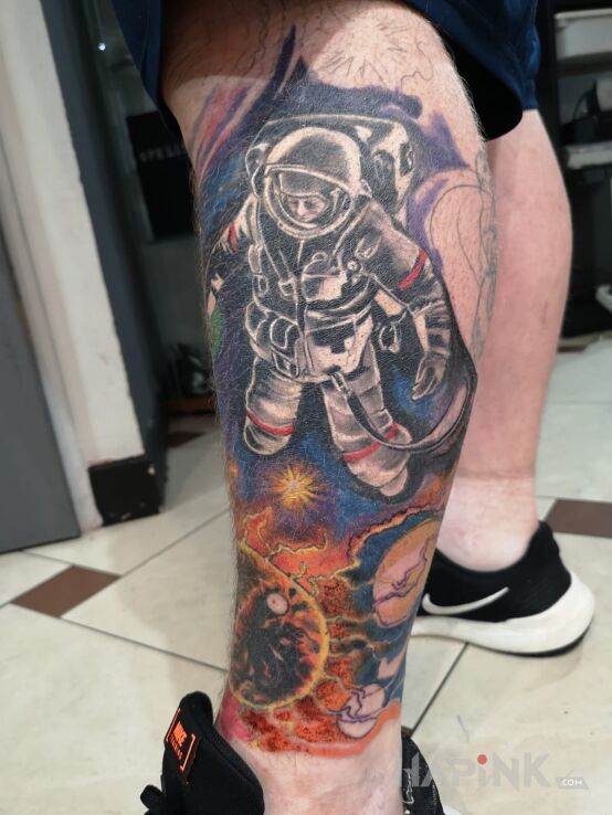 Tattoo Kosmos in colorful motif on the calf