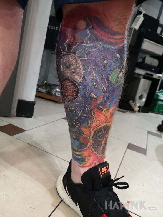 Tattoo Kosmos in colorful motif on the calf