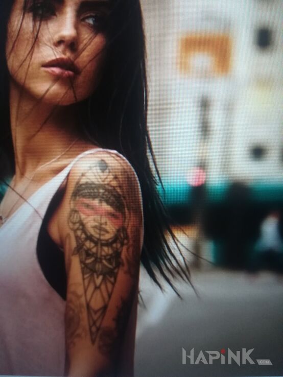 Tattoo Indianin in Indian motif and graphic / illustrative style on the upper arm