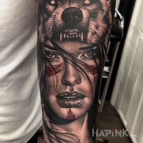 Tattoo Woman wolf on the forearm motif: black and gray style: realistic