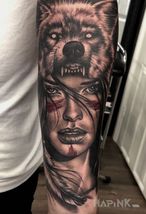 Tattoo Kobieta wilk in faces motif and realistic style on the forearm