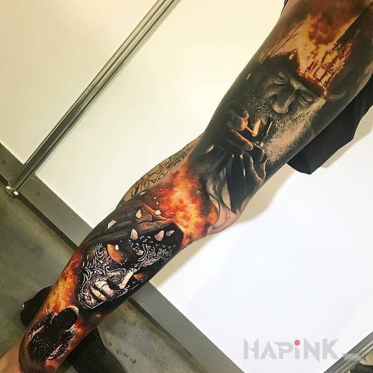 Tattoo Istny oigień! in faces motif and realistic style on the leg