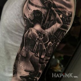 Tattoo Dancer on the upper arm motif: black and gray style: realistic