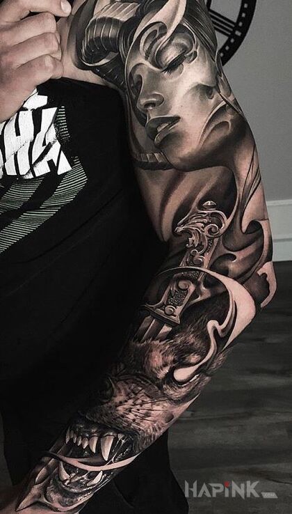 Tattoo Wilk z mieczem w głowie in black and gray motif and realistic style on the upper arm