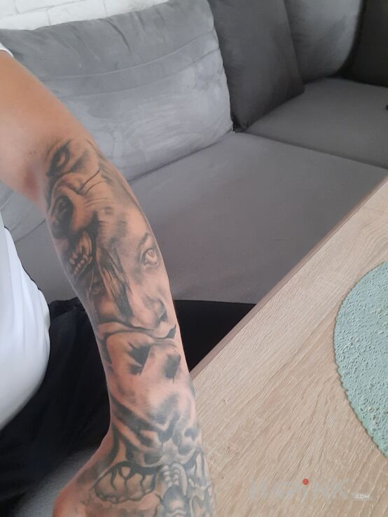 Tattoo Wilk z kobietą in faces motif on the forearm