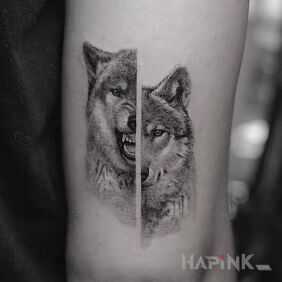 Tattoo The two faces of the wolf on the upper arm motif: animals style: realistic