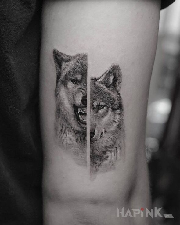 Tattoo Dwa oblicze wilka in black and gray motif and realistic style on the upper arm