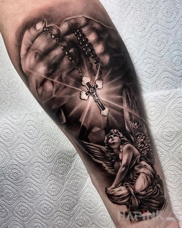 Tattoo Różaniec i anioł in black and gray motif and realistic style on the forearm