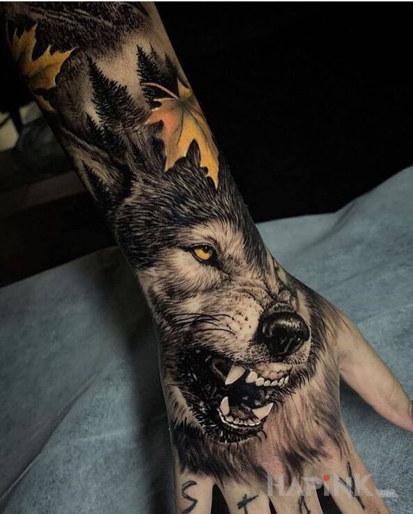 Tattoo Wilk z kłami na wierzchu in black and gray motif and realistic style on the forearm