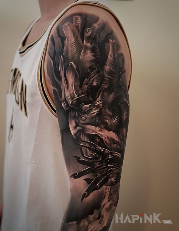 Tattoo Ent in black and gray motif and realistic style on the upper arm