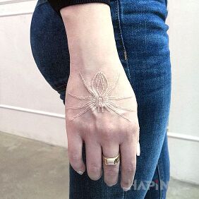 Tattoo White spider on the hand motif: animals style: white ink