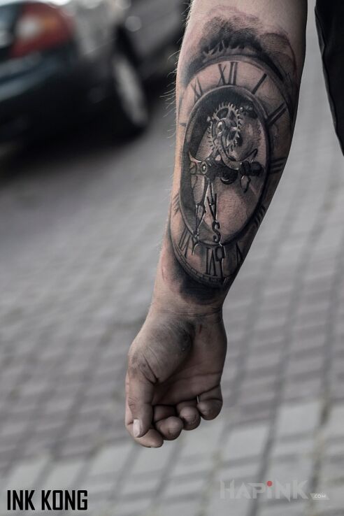 Tattoo Zegar in black and gray motif and realistic style on the forearm