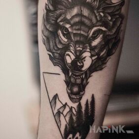 Tattoo Wolf on the forearm motif: black and gray style: graphic / illustrative