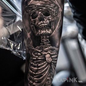 Tattoo Skeleton on the forearm motif: black and gray style: realistic