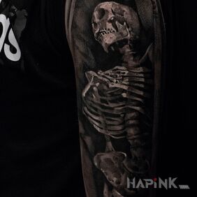 Tattoo Skeletor on the upper arm motif: dark style: realistic