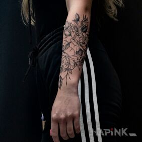 Tattoo Roses on the forearm motif: black and gray style: graphic / illustrative