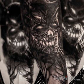 Tattoo Demon on the forearm motif: black and gray style: realistic