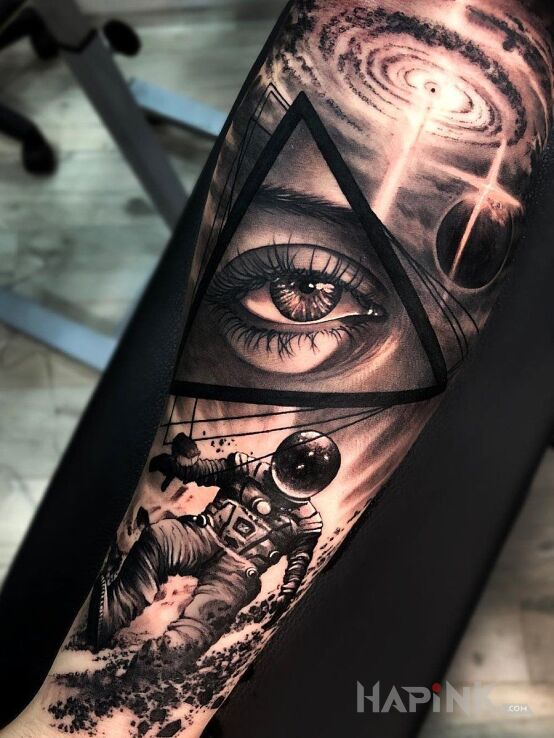 Tattoo Oko w kosmosie in black and gray motif and abstract style on the forearm