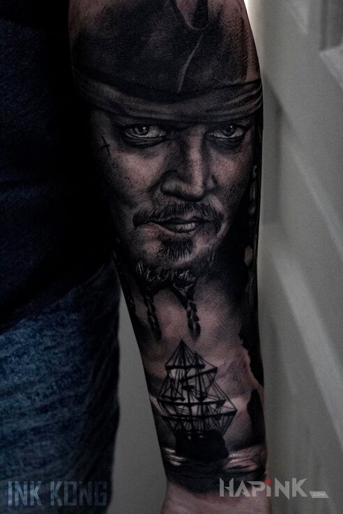 Tattoo Piraci z Karaibów in black and gray motif and realistic style on the forearm