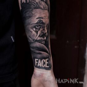 Tattoo Joker on the forearm motif: lettering style: calligraphy