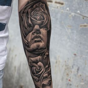 Tattoo Rosewood on the forearm motif: faces style: abstract