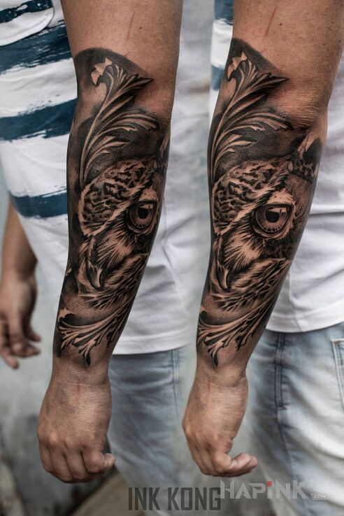 Tattoo Sowa in black and gray motif and realistic style on the forearm