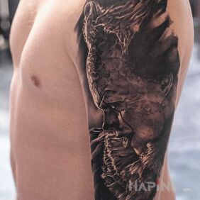 Tattoo "It" Clown on the upper arm motif: faces style: realistic