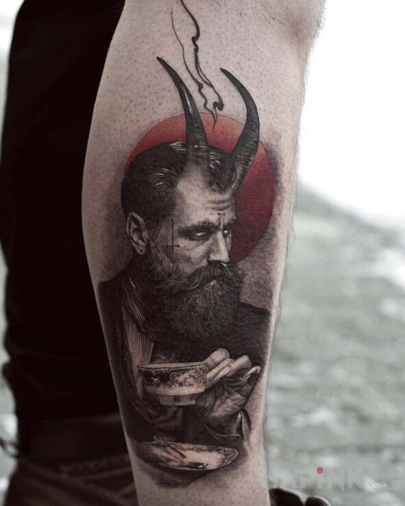 Tattoo Mefistoteles in faces motif and realistic style on the calf