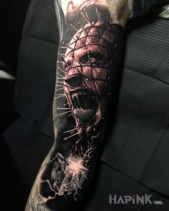 Tattoo Szalony hellraiser in demons motif and realistic style on the upper arm