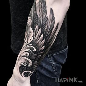 Tattoo A wing on the hand on the forearm motif: black and gray style: realistic