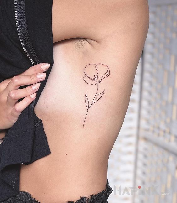Tattoo Maczek in flowers motif and contour / linework style on the ribs