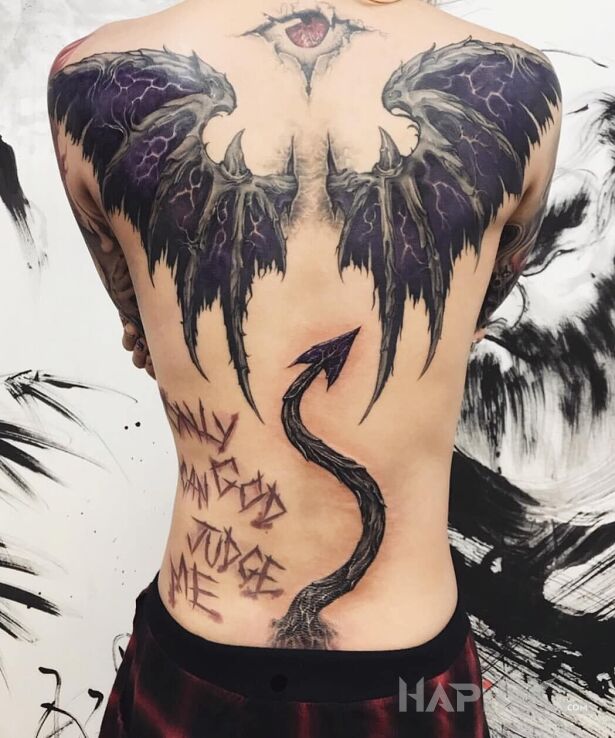 Tattoo Diabełek in wings motif and realistic style on the shoulder blades