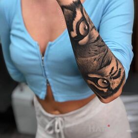Tattoo Eyes of the tiger on the forearm motif: animals style: realistic