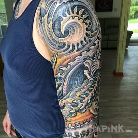Tattoo Spiral like a monster on the upper arm motif: colorful style: organic