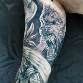 Tattoo Werewolf on the upper arm motif: black and gray style: realistic