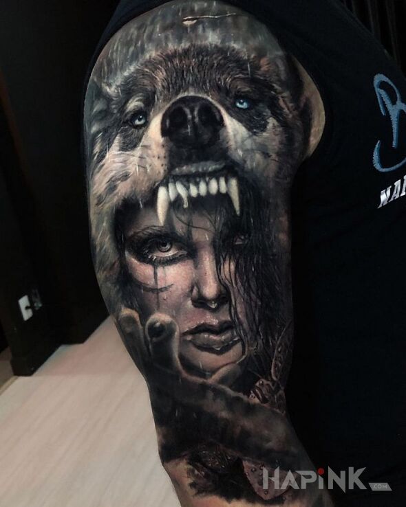 Tattoo Kobieta w paszczy wilka in black and gray motif and realistic style on the upper arm