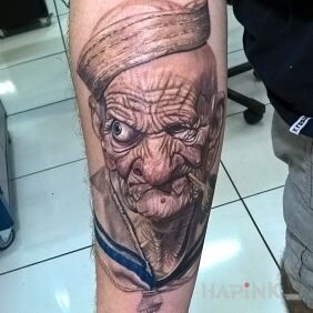 Tattoo Popeye on the forearm motif: characters style: realistic