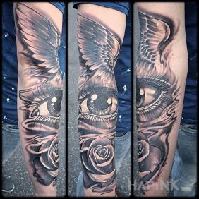 Tattoo Winged eye on the upper arm motif: flowers